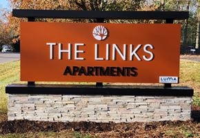 Cincinnati apartment for rent - a sign for the links apartments is shown in front of a stone retaining wall