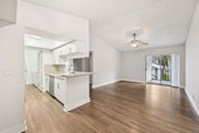 Pompano Beach apartment for rent - A spacious kitchen with white cabinets and a marble countertop.