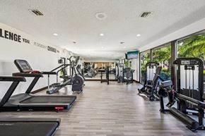 Pompano Beach apartment for rent - A gym with treadmills, weights and exercise machines.