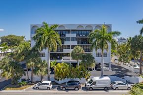 Bay Harbor Islands apartment for rent - a building with palm trees and cars parked in front of it