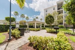 Hialeah apartment for rent - A sunny day at the outdoor seating area of a modern building.
