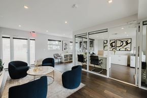 Miami apartment for rent - A modern office space with black chairs and a glass wall.
