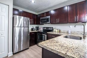 Kendall apartment for rent - a kitchen with stainless steel appliances and granite counter tops