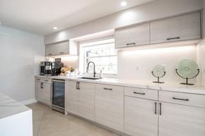 Kendall apartment for rent - a kitchen with white cabinets and a window