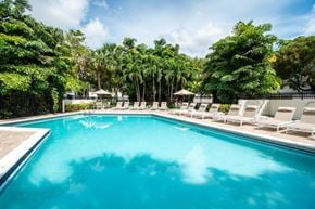 Kendall apartment for rent - a swimming pool at a resort with chairs around it