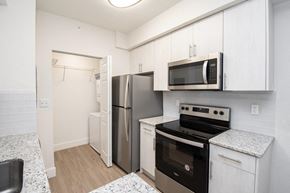 Davie apartment for rent - a kitchen with stainless steel appliances and white cabinets