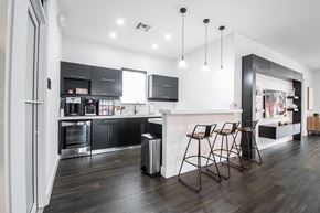 Miami apartment for rent - a kitchen and dining area with a counter and chairs