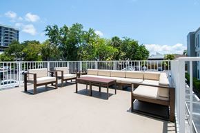 South Miami apartment for rent - A patio with white railings and furniture.