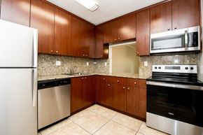 Kendall apartment for rent - a kitchen with stainless steel appliances and wooden cabinets