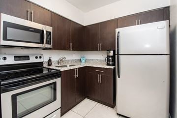 North Miami apartment for rent - a kitchen with a stove microwave and refrigerator
