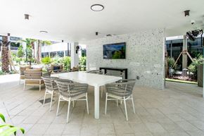 Miami apartment for rent - a dining room with a table and chairs and a fireplace