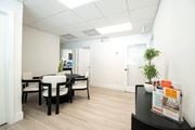 North Miami apartment for rent - A conference room with a table and chairs and a poster on the table.
