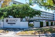 North Miami apartment for rent - A white building with the words "Legacy" and "Sans Souci Apartments 1900" on it.