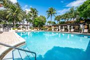 Kendall apartment for rent - a large swimming pool with palm trees in the background