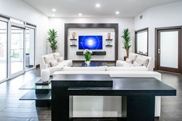 Kendall apartment for rent - A modern living room with a white sofa and a black coffee table.