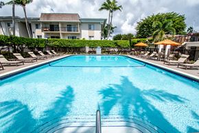 Pinecrest apartment for rent - A swimming pool with a building in the background.