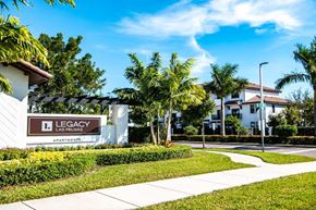 Hialeah apartment for rent - a sidewalk in front of a building with palm trees