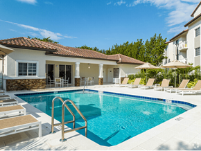 Hollywood apartment for rent - a swimming pool in front of a house with a resort style pool