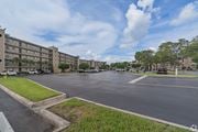 Miramar apartment for rent - A parking lot in front of a building with a cloudy sky.