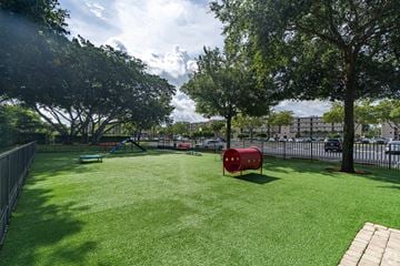 Miramar apartment for rent - A park with a red cylinder object in the middle of the grass.