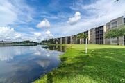 Miramar apartment for rent - A row of modern buildings are reflected in the water.