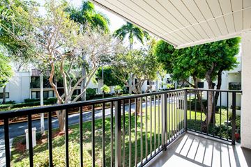Kendall apartment for rent - A balcony with a metal railing and trees in the background.