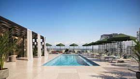 Arlington apartment for rent - A large outdoor swimming pool with lounge chairs and umbrellas.