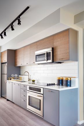 Washington apartment for rent - a kitchen with stainless steel appliances and wooden cabinets