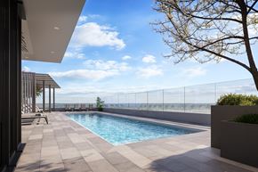 Arlington apartment for rent - A modern pool area with a clear blue sky.
