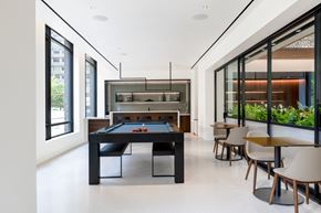 Arlington apartment for rent - a black pool table in the center of a room with tables and chairs