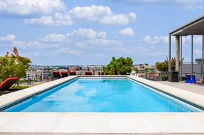 Washington apartment for rent - the pool on the roof of a building with a city in the background
