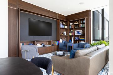 Arlington apartment for rent - A living room with a brown sofa and a black television.