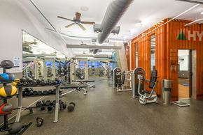 Washington apartment for rent - a gym with weights and cardio machines and a ceiling fan
