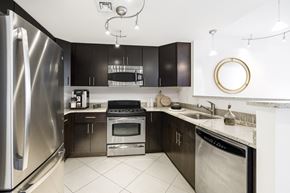 Arlington apartment for rent - a kitchen with stainless steel appliances and black cabinets  at 220 Twentieth Street, Virginia