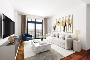 Washington apartment for rent - a living room with a white couch and a television