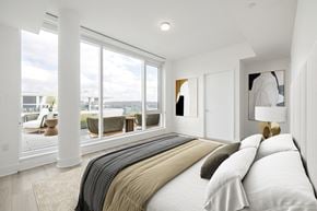Washington apartment for rent - a bedroom with a bed and a large window