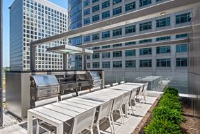Arlington apartment for rent - A modern outdoor dining area with white chairs and tables.