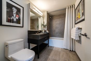 Spa-inspired baths with porcelain tile tubs, showers and floors, custom vanity with quartz countertop, and high-end fixtures