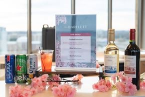 Arlington apartment for rent - A bar menu is displayed on a table with a can of Corona, a glass of orange juice, and three bottles of wine.