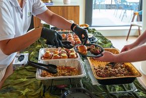 Arlington apartment for rent - A person serving food to another person at a buffet.