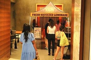 Arlington apartment for rent - A group of people are standing in front of a lemonade stand.