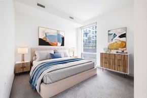 Washington apartment for rent - a bedroom with a large bed and two large paintings on the wall