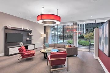 Arlington apartment for rent - a living room with a couch and chairs and a television