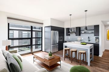 Washington apartment for rent - a living room with a kitchen and a couch and a table