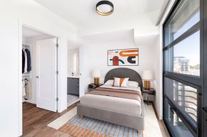 Washington apartment for rent - a bedroom with a large bed and a large window