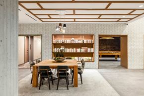 Washington apartment for rent - a dining room with a wooden table and chairs and a book shelf