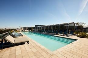 Washington apartment for rent - a pool on the rooftop of a hotel with lounge chairs