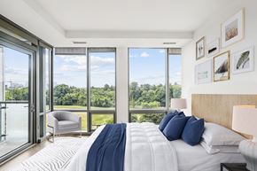 Washington apartment for rent - a bedroom with a bed and a view of a large window