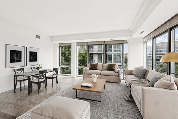Washington apartment for rent - a living room with couches and a coffee table   and a dining table