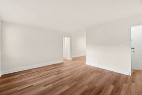 Falls Church townhouse for rent - A room with wooden flooring and white walls.